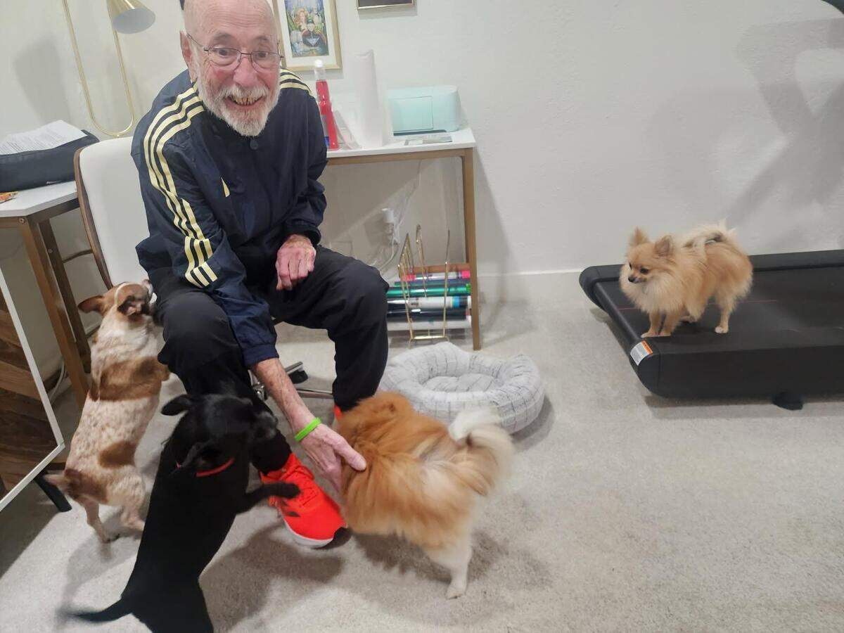 Mel Gregory surrounded by beloved dogs.