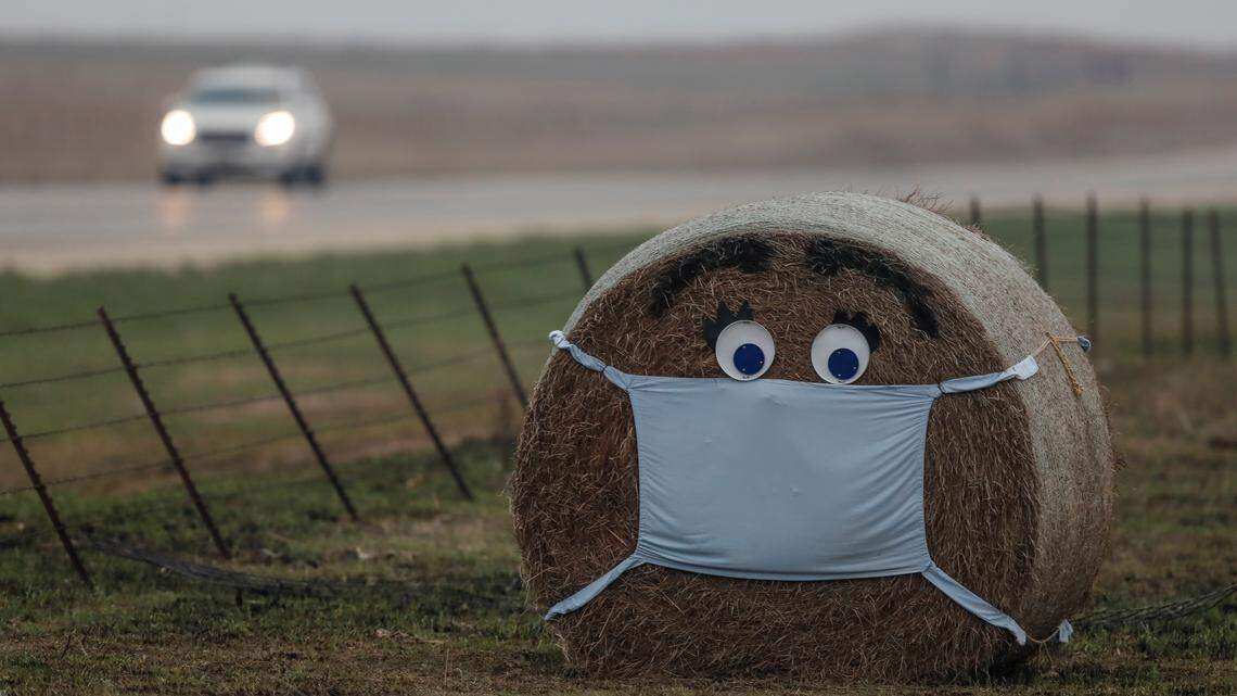 A hay bale along the edge of a cattle pasture near Florence is adorned with a face and surgical mask. As of Monday, April 6, 2020, public health officials report 845 positive cases of COVID-19 in Kansas.