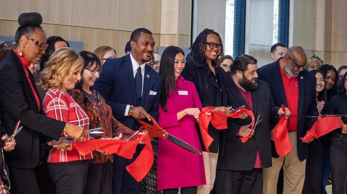Wichita Mayor Lily Wu, District 1 City Council member Brandon Johnson and other public figures cut the ribbon at the reopening of the Carl G. Brewer Community Center.