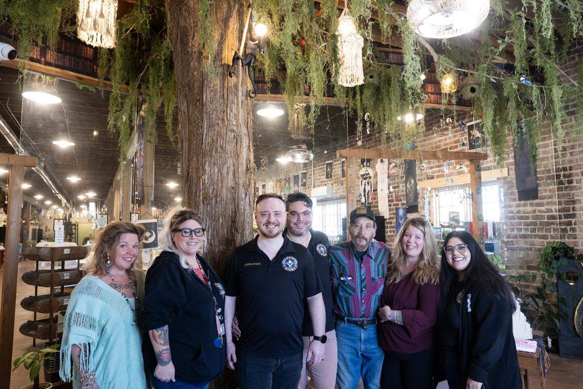 Husbands Johnathan and Giovanni Von Cartier, center in black shirts, have the eclectic new Connect with Source store downtown that offers a variety of merchandise and services. They’re shown with their staff and supporters.