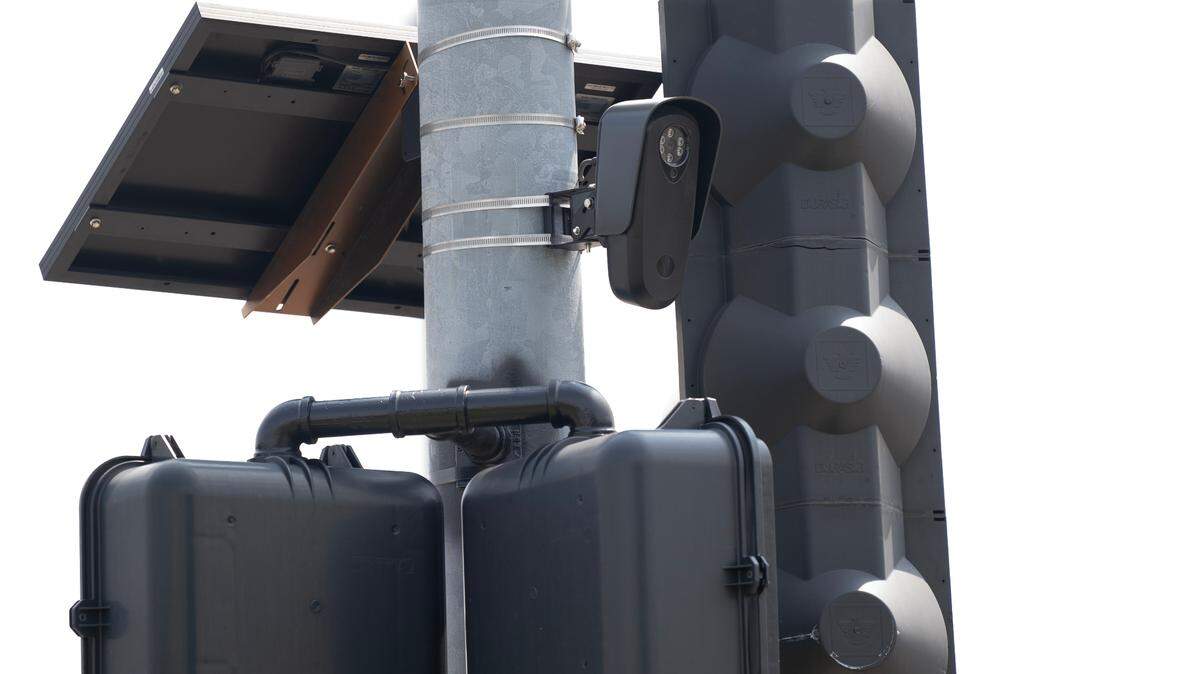 A Flock Safety device hangs from a light pole at the intersection of 13th and Grove where police are testing the company’s gunshot sensors. Police have been using the company’s license plate readers for several years but recently announced they would purchase the company’s gunshot sensors as well.