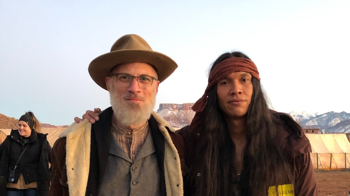 Wichita native Matt Combs, left, makes a brief, somewhat surprise acting appearance in Kevin Costner’s new “Horizon: An American Saga.” He’s pictured with actor Owen Crowshoe, who plays an Apache warrior who kills him with three arrows while trying to steal his fiddle.