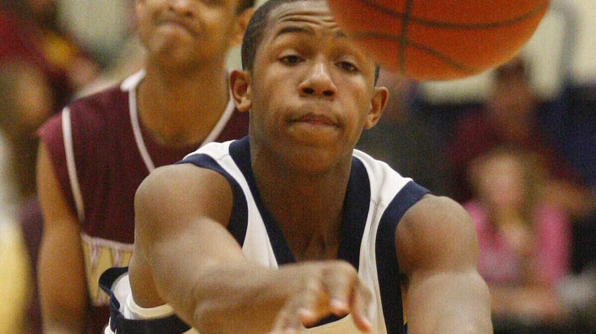 Northwest's Craig Nicholson dishes the bal off after penetrating West's defense in the 4th quarter Friday (Feb. 12, 2010) at Northwest High.