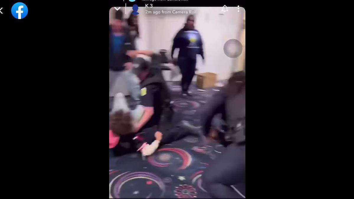 This image is taken from a cell-phone video, widely circulated on Facebook and YouTube, showing a Wichita Police officer preparing to punch a 16-year-old boy during an altercation at a Wichita roller rink.