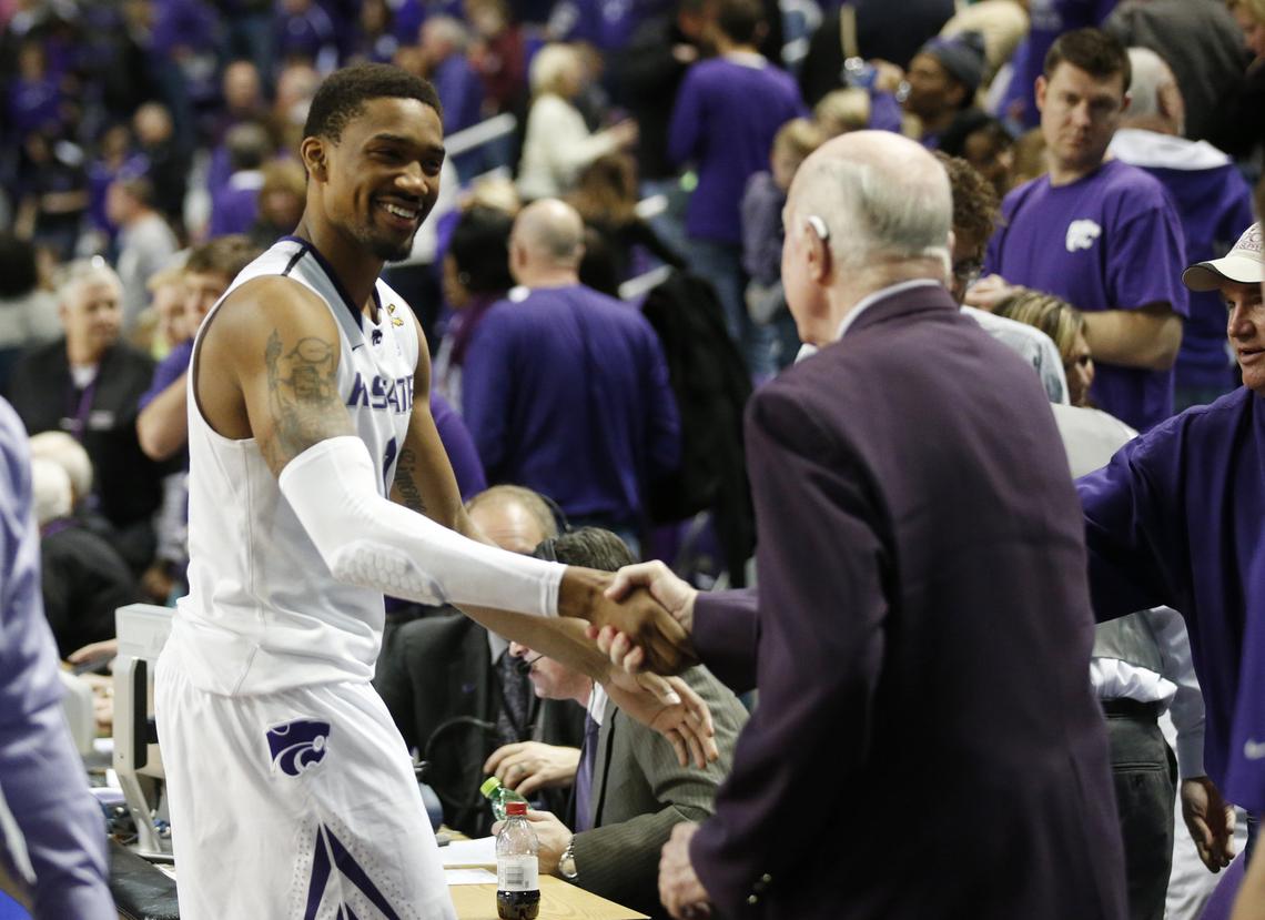 K-State guard Shane Southwell (1) shakes hands with Ernie Barrett Saturday after the Wildcats defeated West Virginia 78-56. Southwell had 20 points for the day. (January 18, 2014)