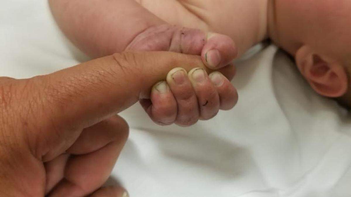 A 5-month-old baby was found face down and buried under sticks and debris after a deputy heard a "faint cry" in the Montana mountains.