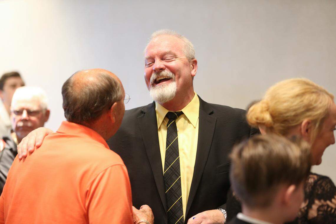 New Wichita State University baseball coach Eric Wedge talks with Bob Hanson during Wedge’s first appearance after being named head coach.