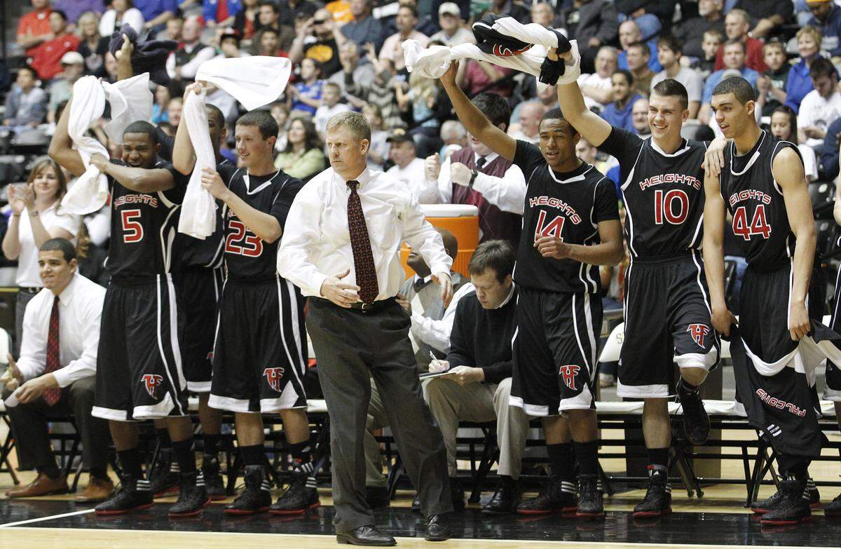 Heights' coach Joe Auer and the rest of the bench cheer their team on during the Class 6A championship game at the state basketball tournament at Koch Arena in Wichita, Kan., Saturday.  Heights beat Blue Valley Northwest 67-60. (March 10, 2012)