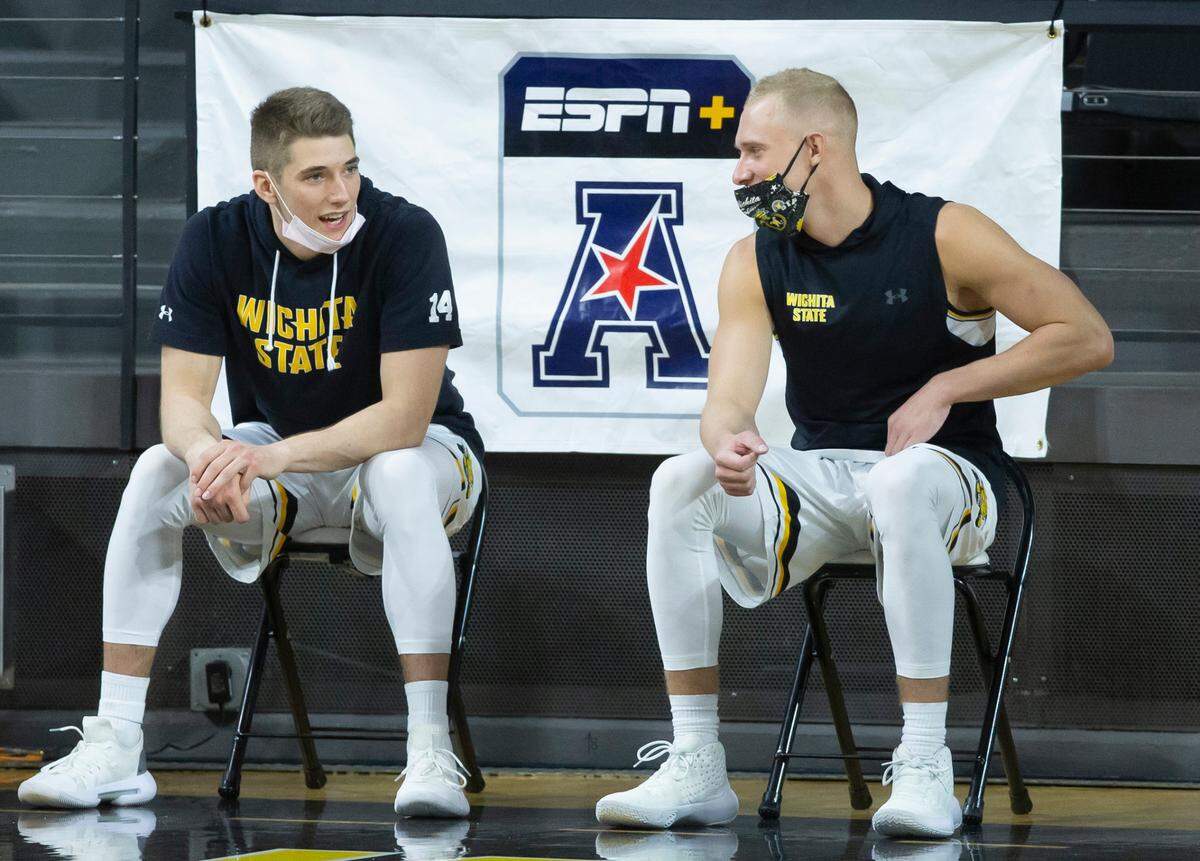 Wichita State seniors Jacob Herrs, left, and Brycen Bush sit on the bench during Wichita State’s final home game on Saturday. 