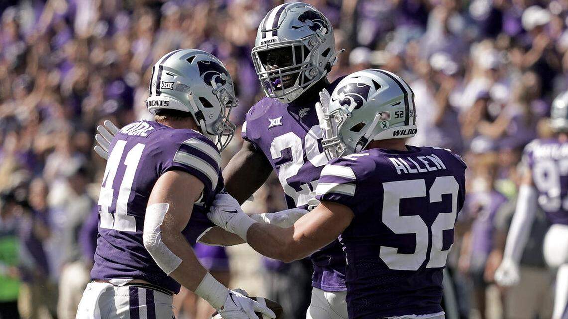 Kansas State linebacker Austin Moore (41) celebrates with linebackers Khalid Duke (29) and Nick Allen (52) after intercepting a pass during the first half of an NCAA college football game against Texas Tech Saturday, Oct. 1, 2022, in Manhattan, Kan. (AP Photo/Charlie Riedel)