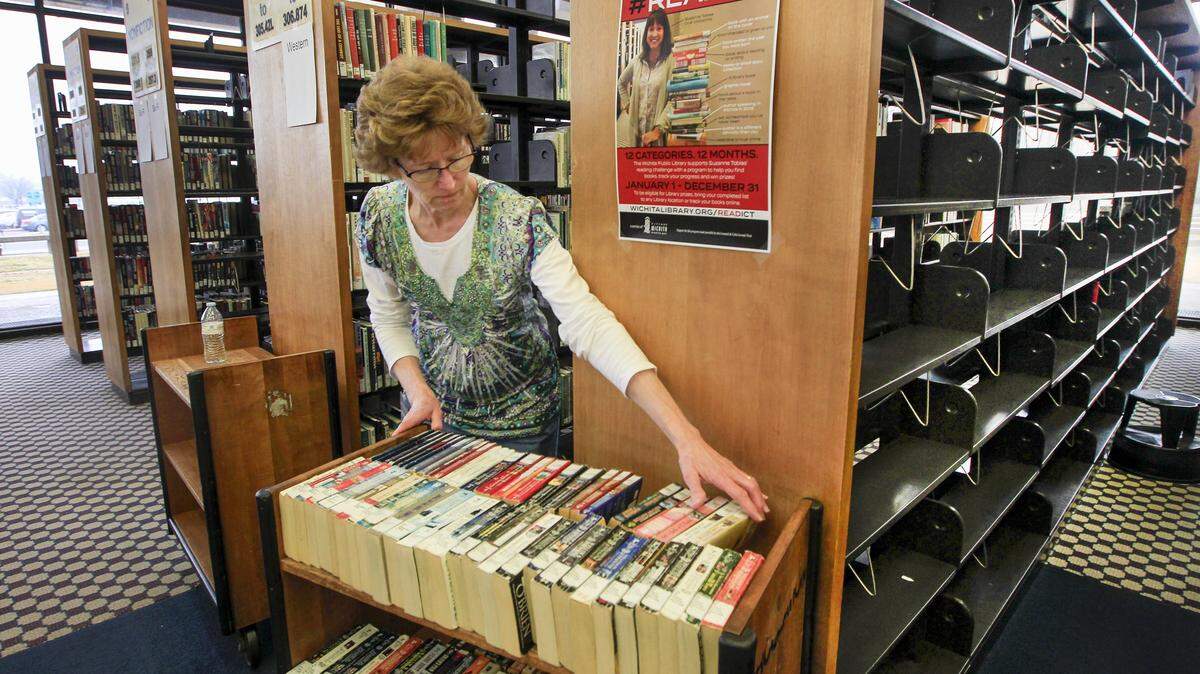Senior librarian assistant Sherryl Torres, who has worked at the library for nearly 40 years, stocks the shelves at the downtown library Monday. A lot of the shelves are empty there as they prepare for the move to the new Advanced Learning Library near Second and McLean.