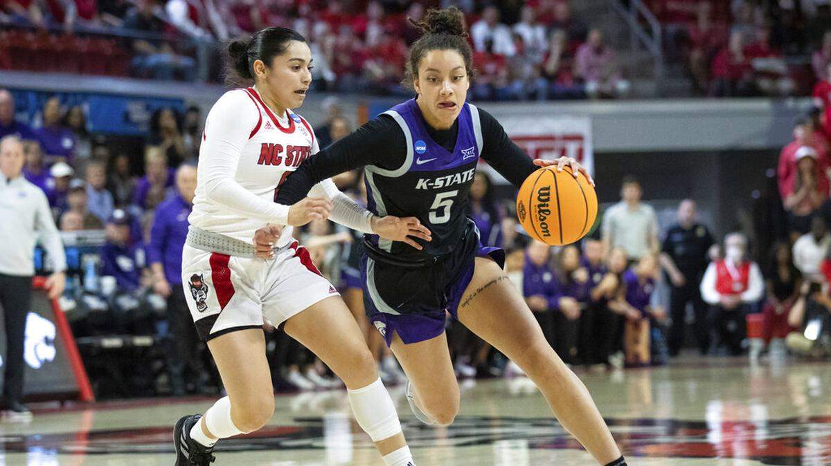 Kansas State’s Brylee Glenn (5) drives against North Carolina State’s Raina Perez, left, during the first half of a college basketball game in the second round of the NCAA tournament in Raleigh, N.C., Monday, March 21, 2022. (AP Photo/Ben McKeown)