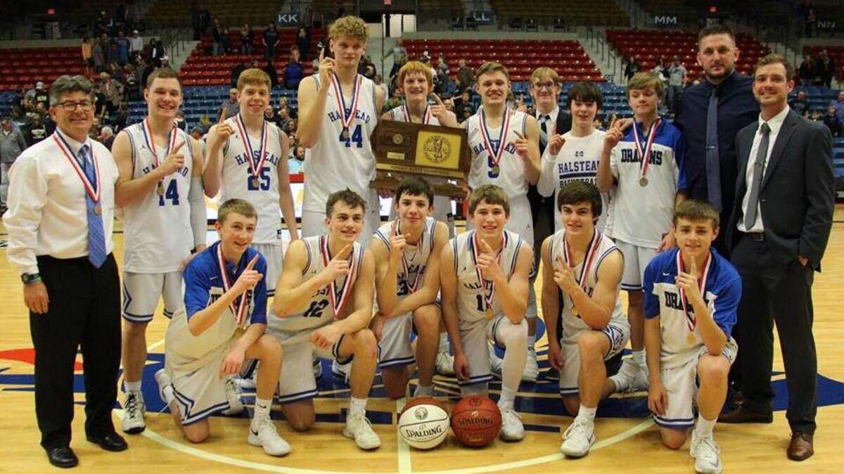 The Halstead boys basketball team celebrates the Class 3A state championship, a 44-42 buzzer-beating victory against Phillipsburg on March 10, 2018, at the Hutchinson Sports Arena.