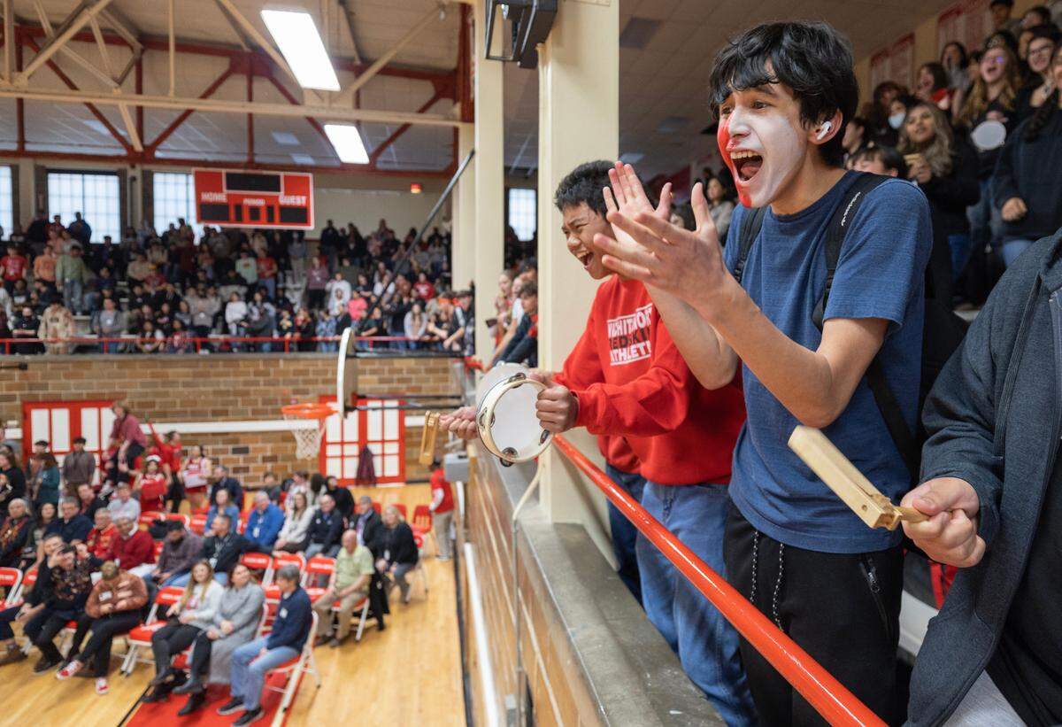 North High students cheer during a pep rally on Thursday where the new logo for the Redhawks name was unveiled.