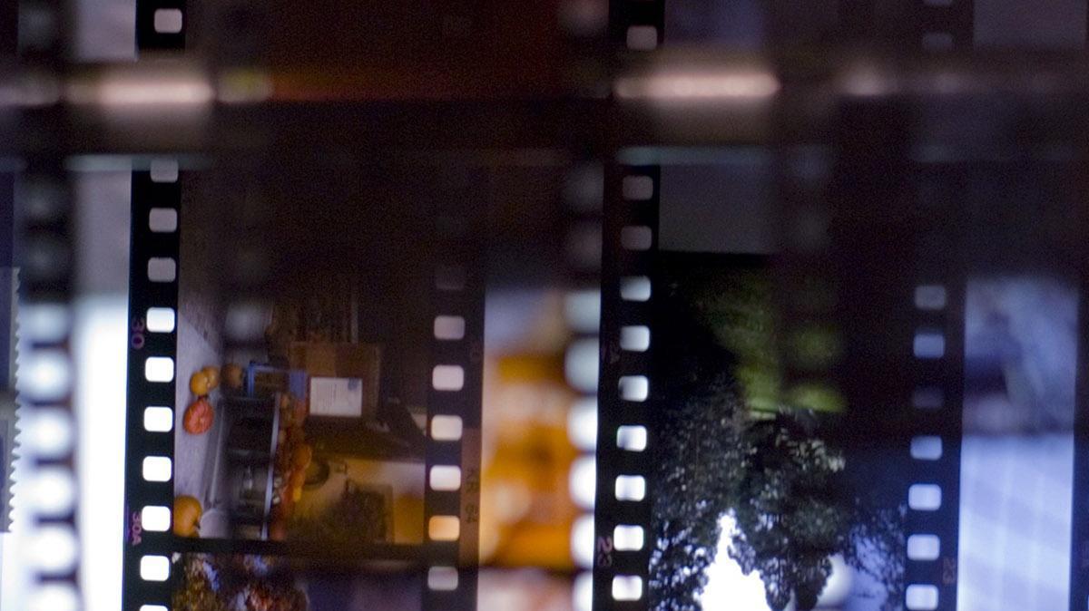 Strips of Kodachrome slide film travel past an inspection light during  processing at Dwayne's Photo in Parsons, Kan. It takes eight seconds for a 36- exposure roll of film to pass a given point in the film processing machine.