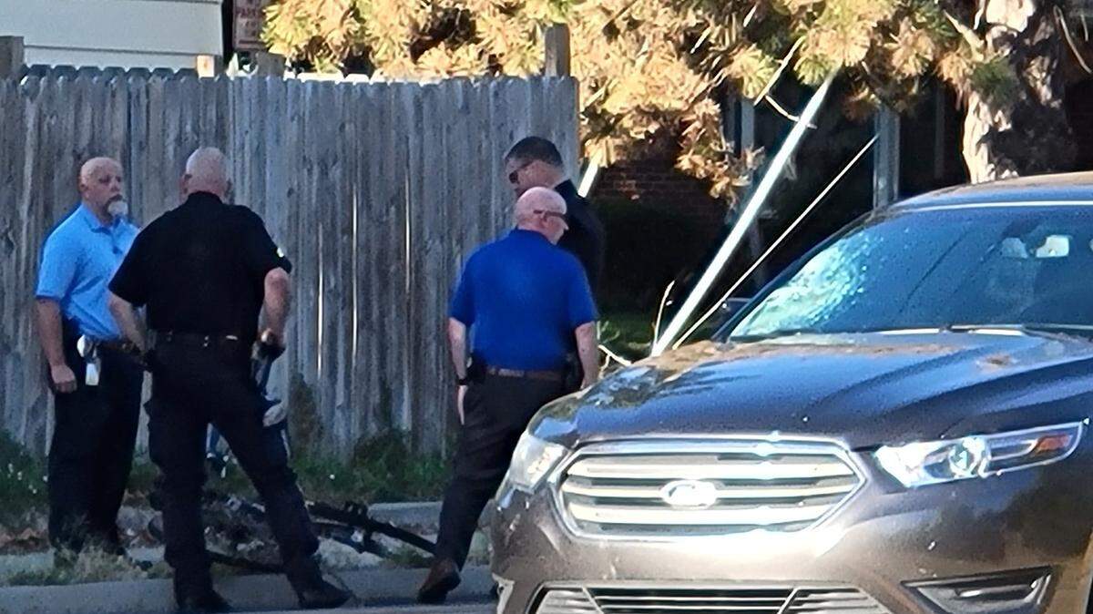 Wichita police crowd around a bicycle that an 11-year-old was hit on while riding to school Tuesday morning at Central and Redbarn. The car that hit him has a damaged windshield.