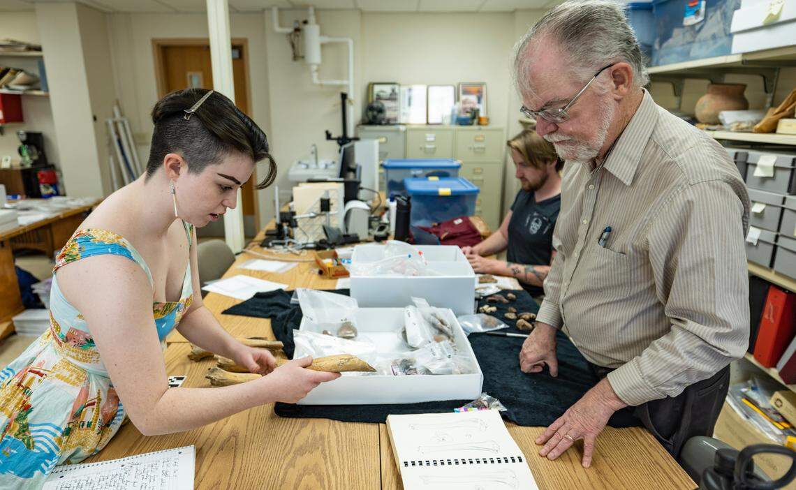 Wichita State University anthropology professor Don Blakeslee helps graduate student Siofra Lynch catalog artifacts thought to be from the Native American town of Etzanoa near present day Arkansas City.