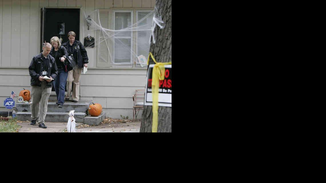 Investigators leave the neighboring house of missing Missouri 10-month-old Lisa Irwin in October.