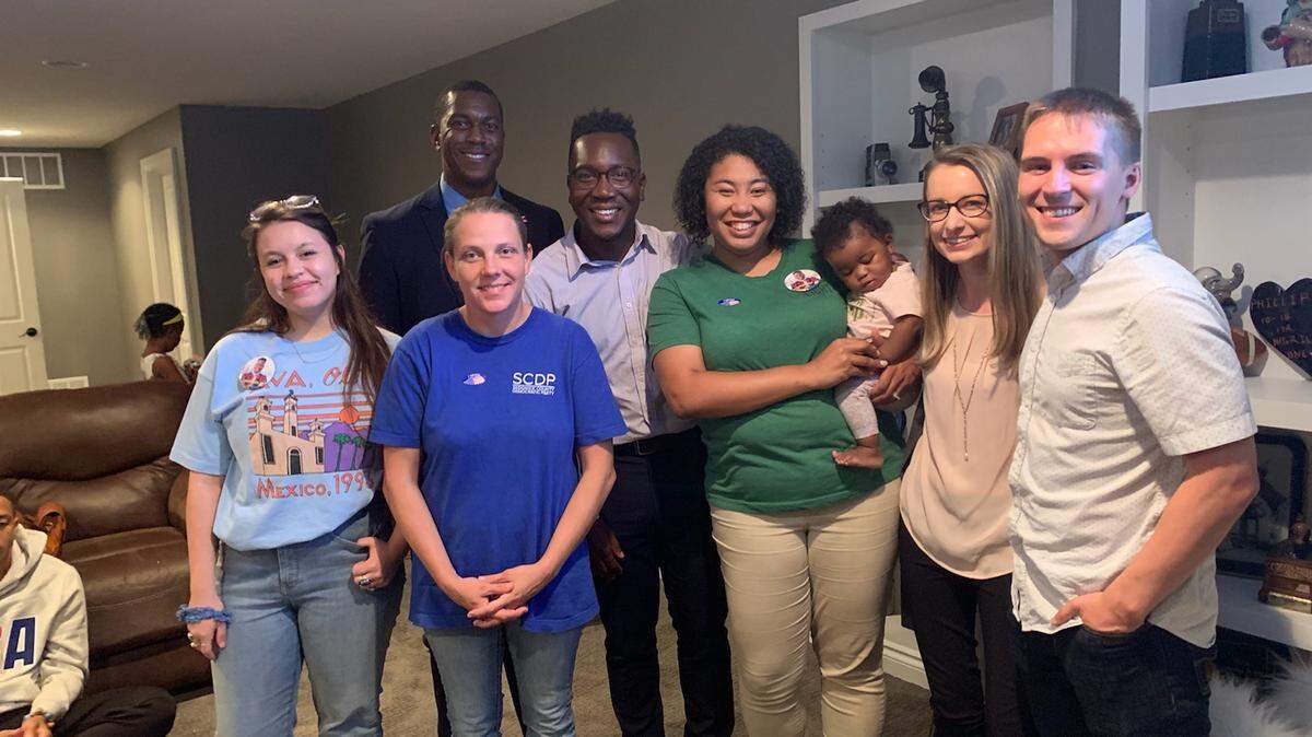 Joseph Shepard, fourth from left, is moving on to the general election for the school board’s at-large seat. He’s shown celebrating with friends, including City Council member Brandon Johnson to his right, and family during a watch party. Shepard will face incumbent Sheril Logan.