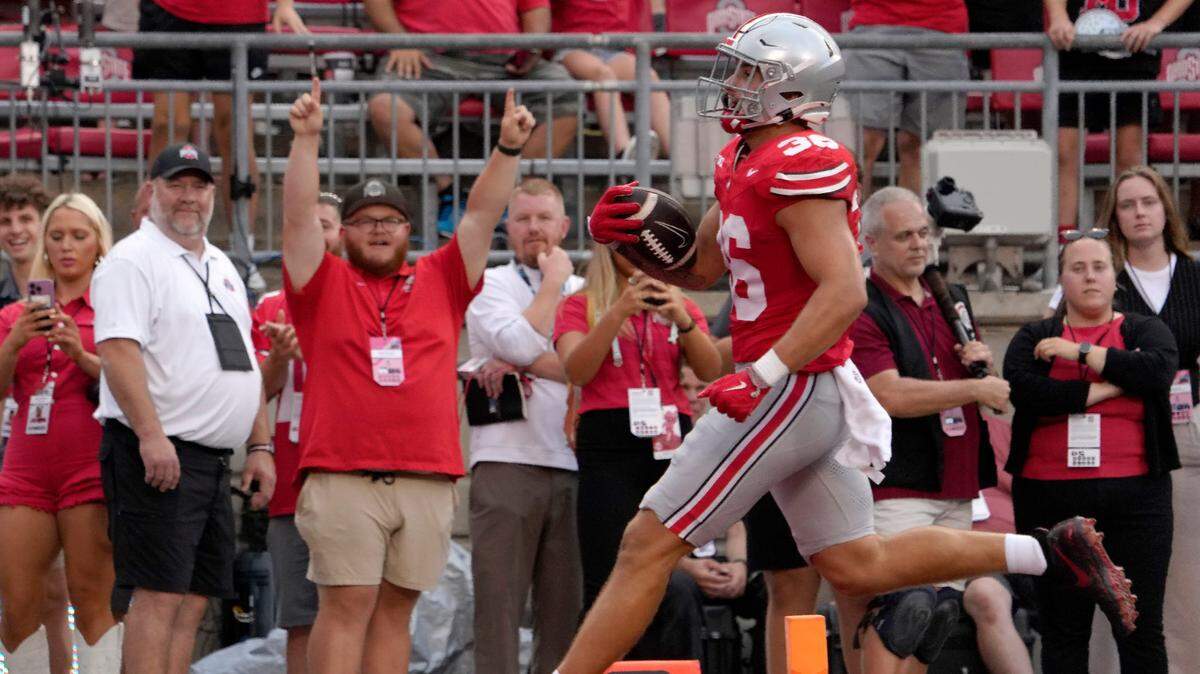 Ohio State Buckeyes linebacker Gabe Powers (36) runs back an interception for a touchdown during the second half of Saturday’s NCAA Division I football game against the Akron Zips at Ohio Stadium.