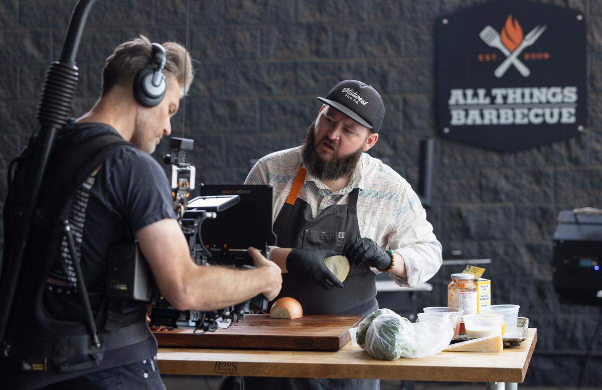 Tom Jackson shoots a cooking demonstration video with the help of Justin Cary. Jackson is the staff chef at All Things Barbecue in Delano. His videos on the store’s official YouTube channel have racked up millions of views.