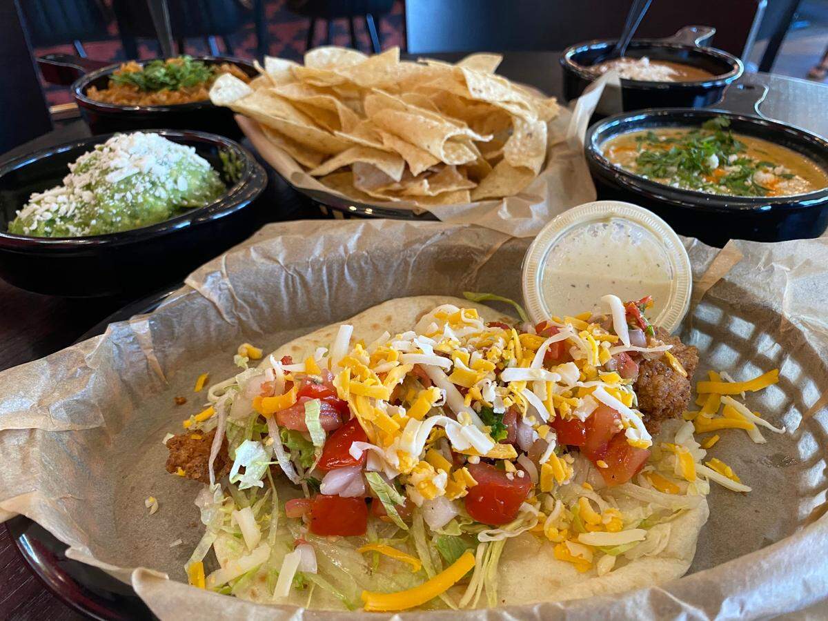 Torchy’s Tacos is known for its green chile queso and for its Trailer Park taco, filled with fried chicken.