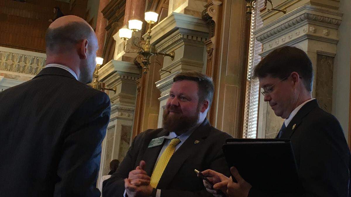 Rep. Blaine Finch, R-Ottawa, speaks with Rep. Scott Schwab, R-Olathe, left, as Rep. Fred Patton, R-Topeka, looks at his phone. Kansas lawmakers debated a fix on Saturday to an $80 million error in the Legislature's school funding plan.