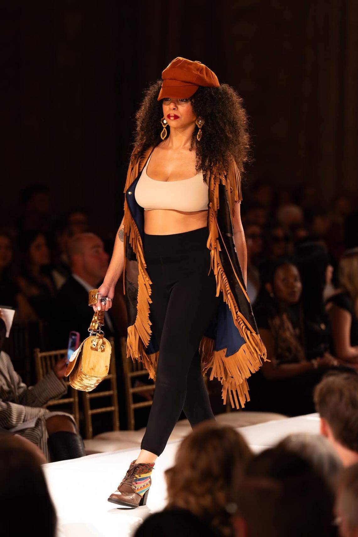 A model at Kansas City Fashion Week shows a long vest that Wichita designer Aida Stenholm created.