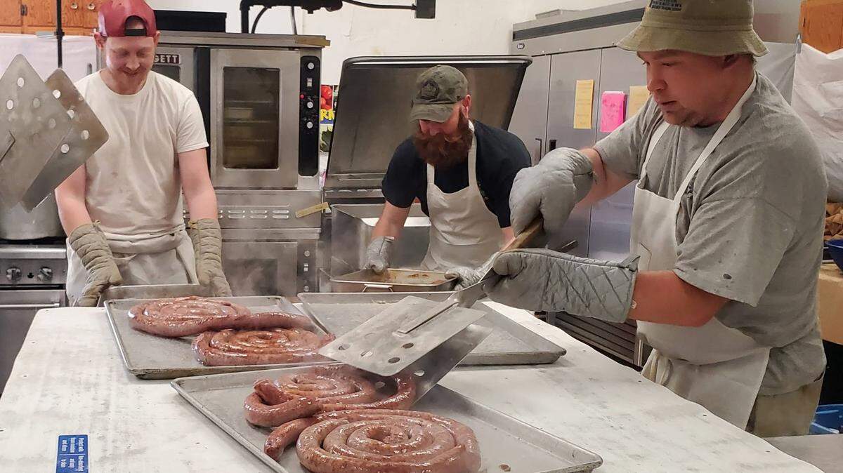 Parishioners at the St. Joseph Catholic Parish are pictured preparing German sausage for last year’s parish dinner.