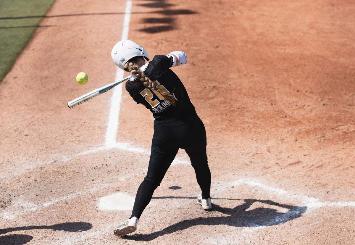 Former Wichita State star Sydney McKinney drives a ball for a base hit in the AUX Pro Softball league at Wilkins Stadium.