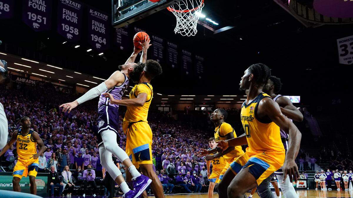 Kansas State forward Ismael Massoud (25) has his shot blocked by Marquette forward Oso Ighodaro with seconds remaining in an NCAA college basketball game Wednesday, Dec. 8, 2021, in Manhattan, Kan. Marquette won 64-63.