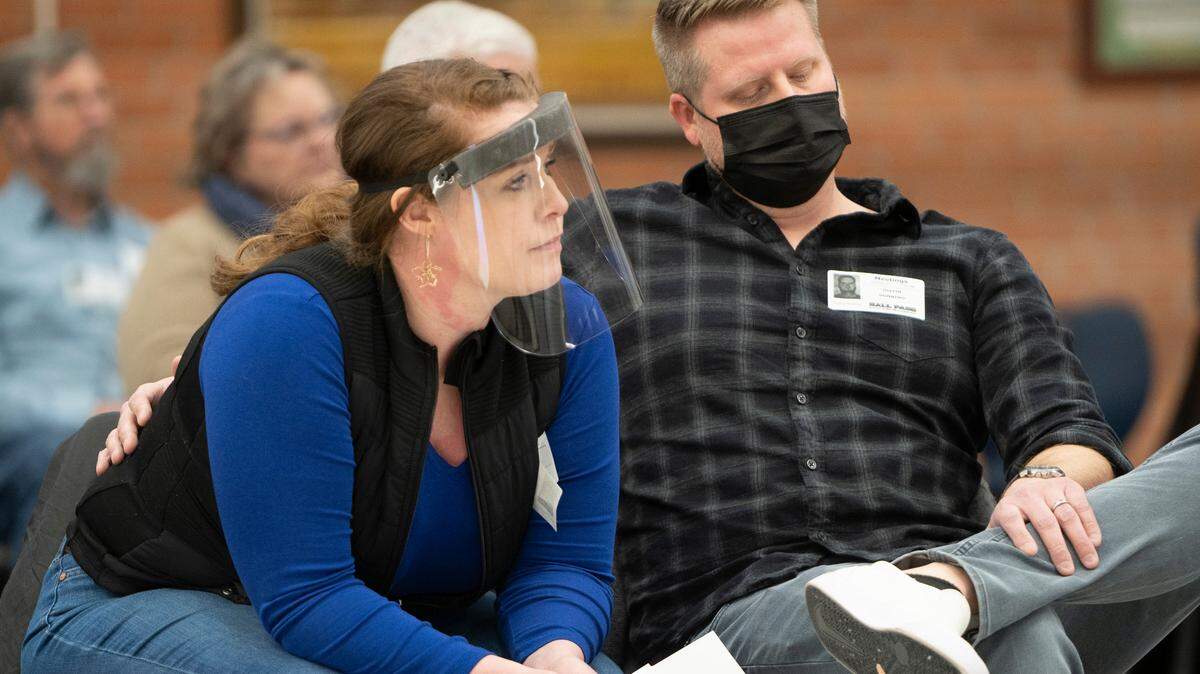 Heather and Justin Dunning sit down after speaking at the USD 259 school board meeting Tuesday about masks. They have two children in the school district and think masks should be optional.