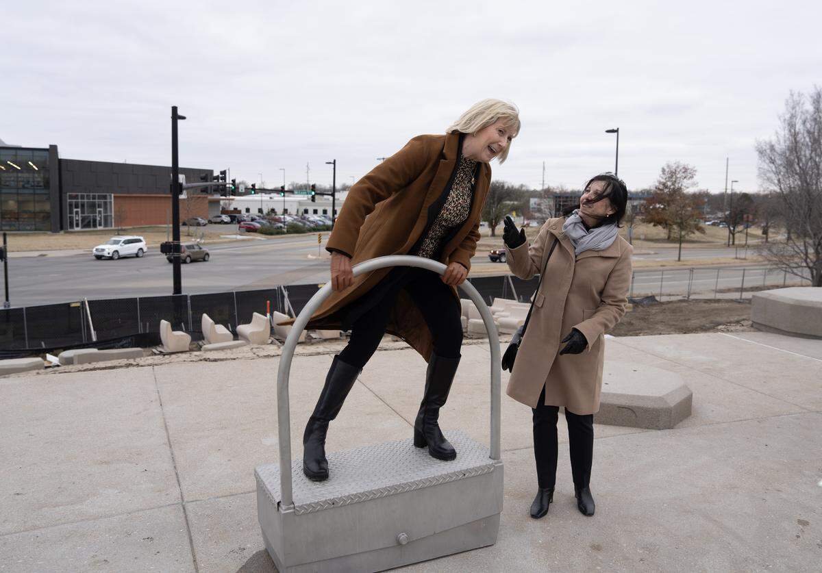 Junior League of Wichita’s Lynn Ward, left, demonstrates one of the interactive water pump features of the Junior League of Wichita Water Play Cascades. She’s’ pictured with Betsy Redler, right.