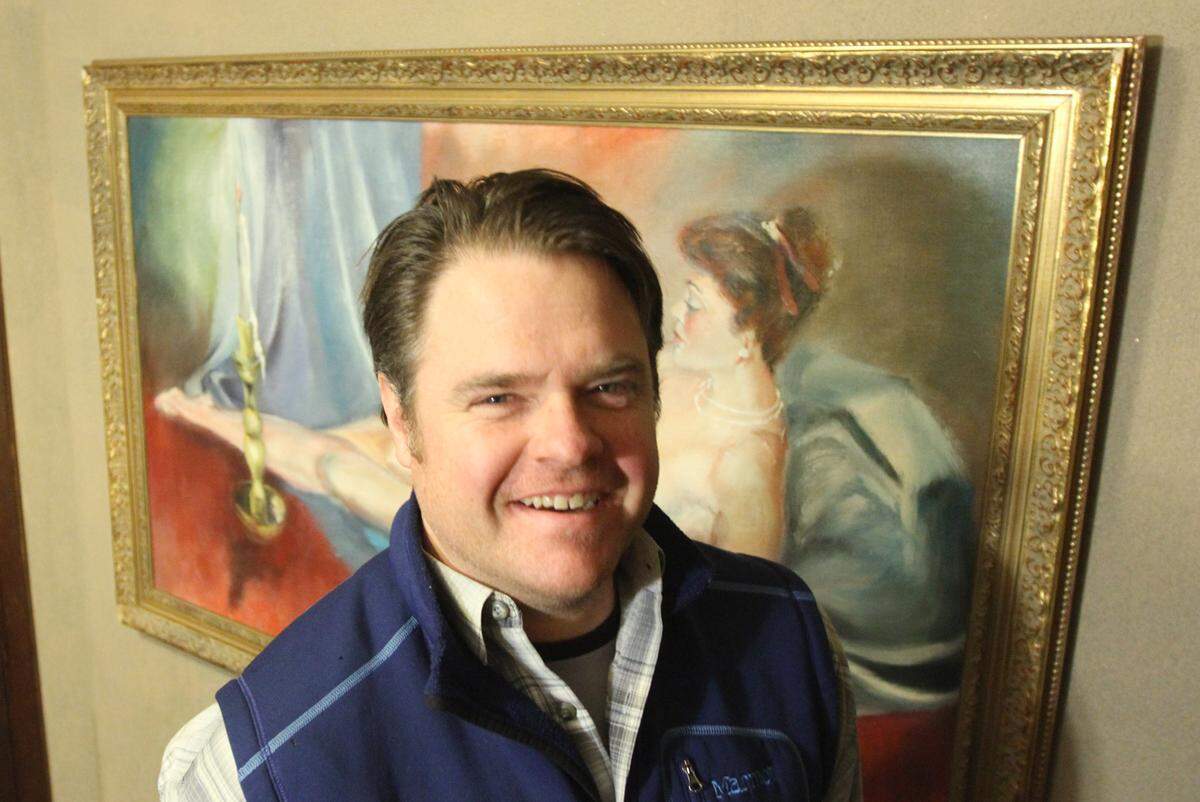 Former Candle Club general manager John Fitzhum stood strategically in front of a new nude painting hanging in the men’s room of the Candle Club in early 2014 after the much-admired original painting was stolen in 2013.