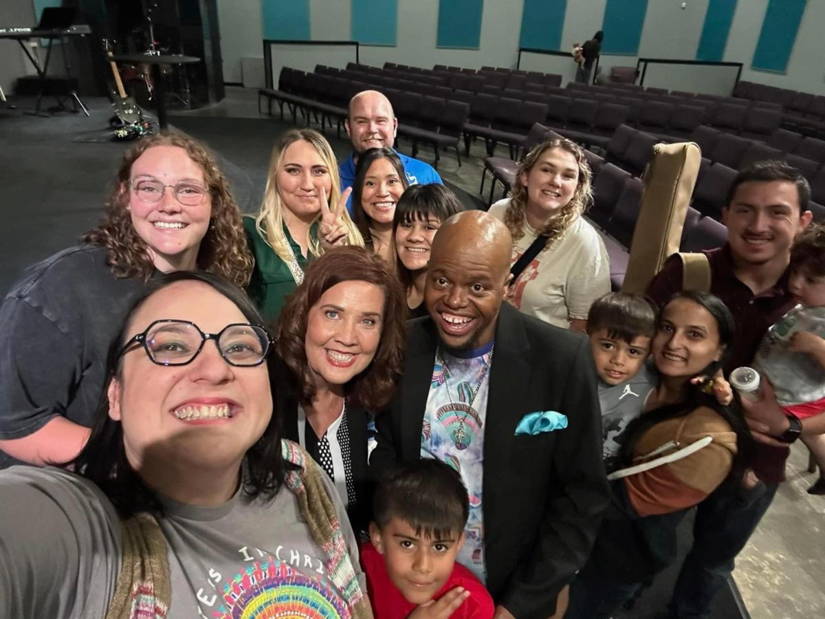 Mariana Christian poses with some of the members of her church while holding one of Mariah Arriaga’s sons, Mateo.