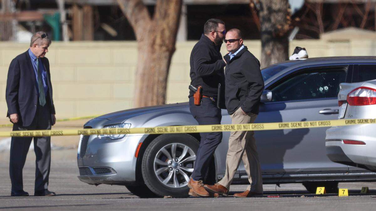 Wichita police detectives look over a car that was involved in a shooting in the parking lot of the Dillons at 21st and Maize Road.