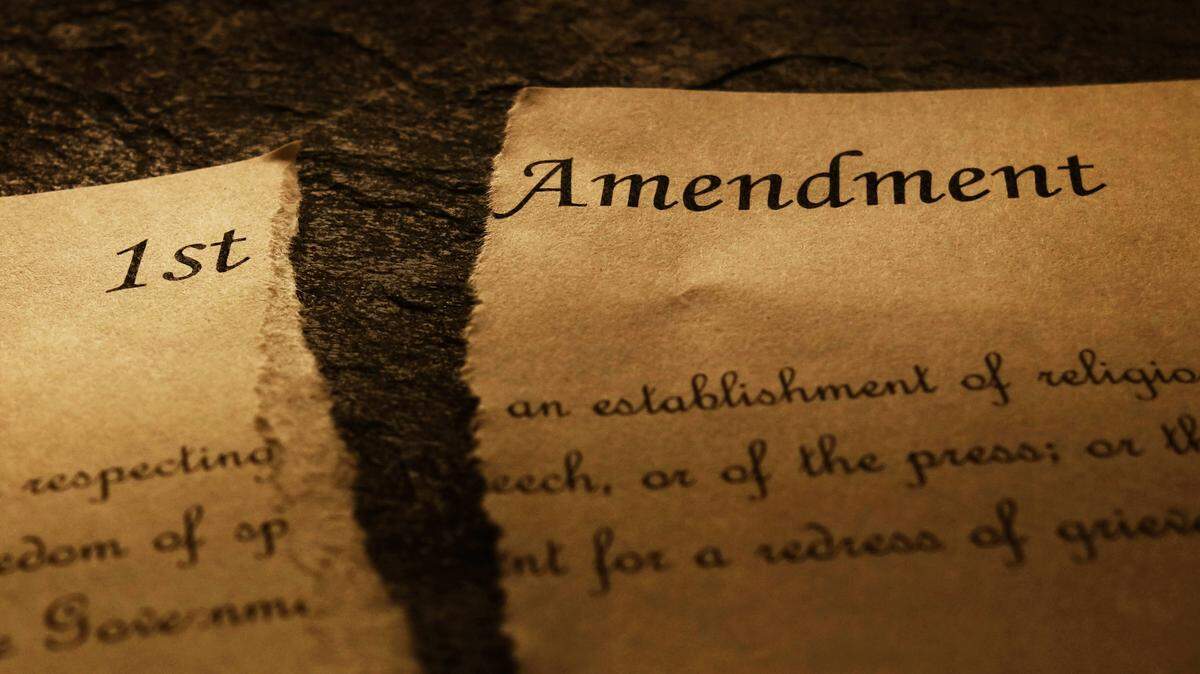 An image of the First Amendment text of the US Constitution ripped in half 