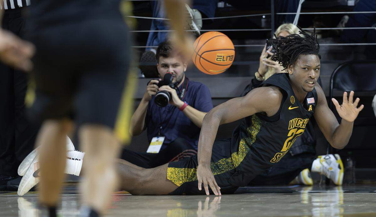 Wichita State’s Noah Hill dives to try and prevent a ball from going out of bounds during the second half against East Carolina on Wednesday night.