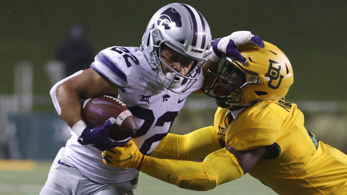 Kansas State running back Deuce Vaughn (22) is tackled Baylor linebacker Ashton Logan (34) in the first half of an NCAA college football game, Saturday, Nov. 28, 2020, in Waco, Texas. (Jerry Larson/Waco Tribune-Herald via AP)