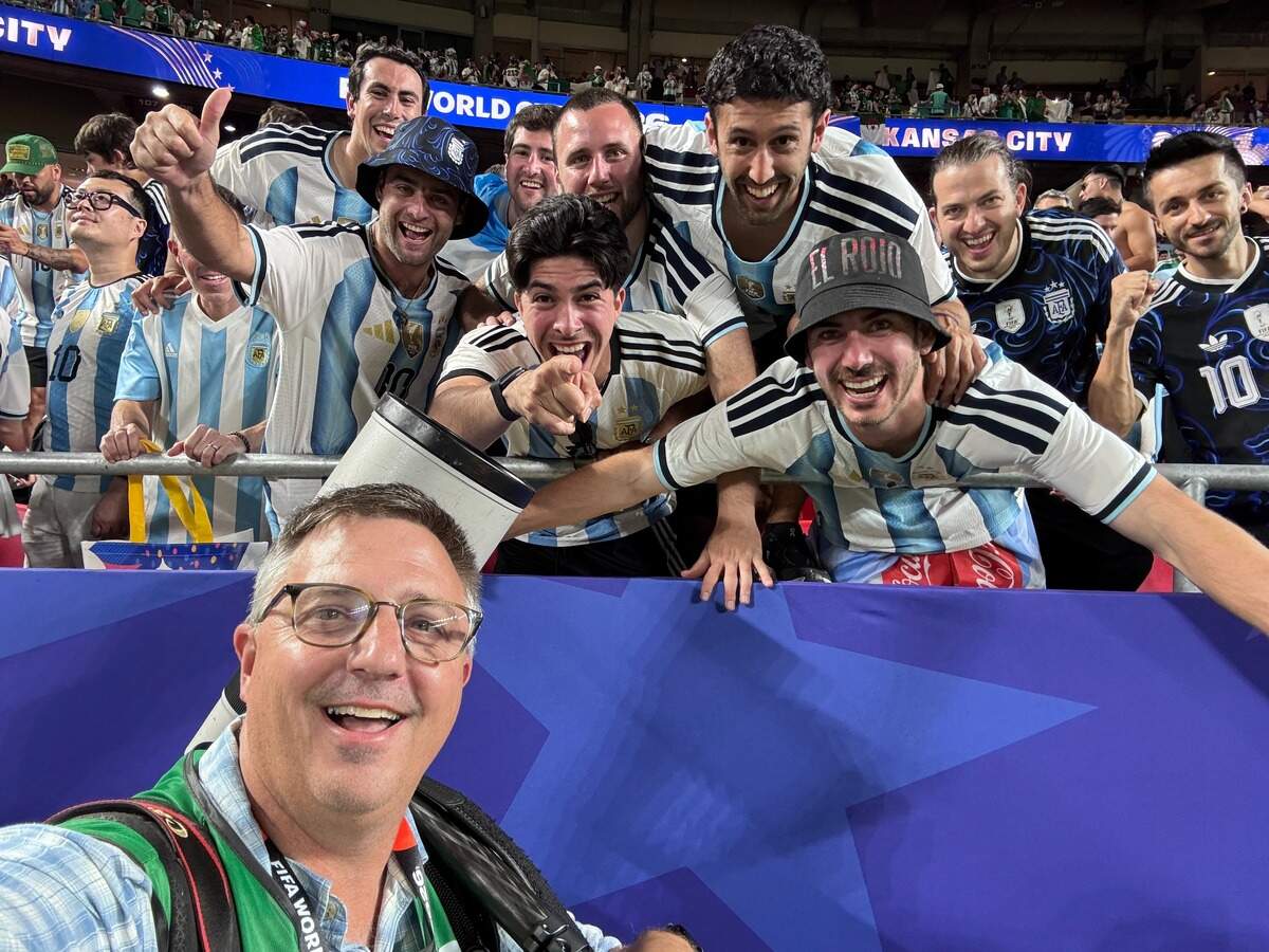 Wichita Eagle photographer Travis Heying takes a selfie with Argentina fans after their win over Algeria in the opening game of the World Cup in Kansas City.