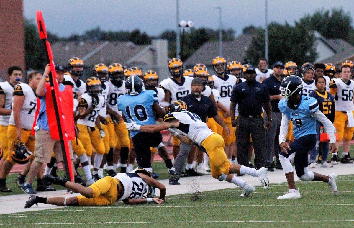Wichita Northwest senior cornerback Josh Gillenwater hits East senior receiver D’Ron Jacobs out of bounds in the Grizzlies’ 56-0 win over the Blue Aces on Thursday night. (Sept. 6, 2018)