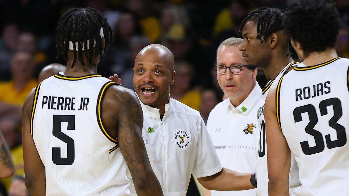 Wichita State assistant coach Billy Kennedy (background) has found a way to combat Parkinson’s disease while coaching with the Shockers.