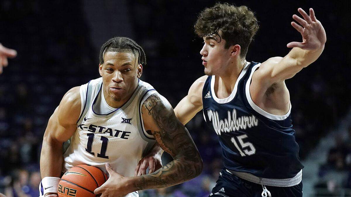 Kansas State’s Keyontae Johnson (11) drives under pressure from Washburn’s Zaid Dajani (15) during the first half of an exhibition NCAA college basketball game Tuesday, Nov. 1, 2022, in Manhattan, Kan. (AP Photo/Charlie Riedel)