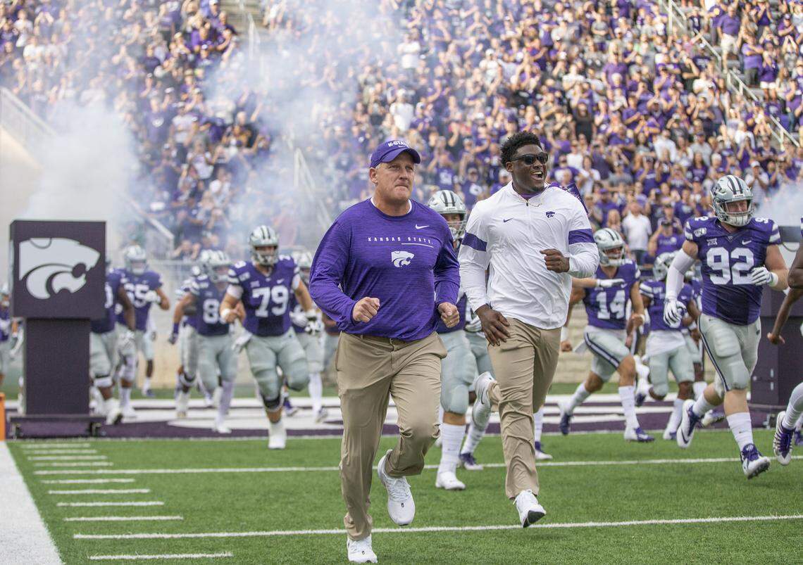 New Kansas State football coach Chris Klieman leads his team onto the field before their game against Nicholls State on Saturday night at Bill Snyder Family Stadium.