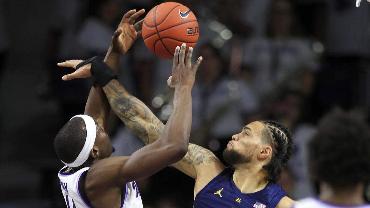 Marquette forward Theo John (4) blocks a shot by Kansas State forward Makol Mawien (14) during the first half of an NCAA college basketball game in Manhattan, Kan., Saturday, Dec. 7, 2019. (AP Photo/Orlin Wagner)