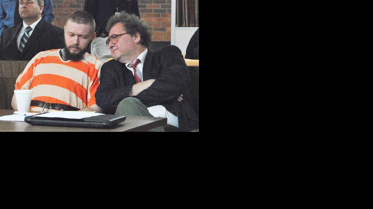 Kyle T. Flack, who is charged in connection with the killing of three adults and an 18-month-old girl in 2013, talks Monday morning with his court-appointed lawyer, Ron Evans, head of the Kansas Death Penalty Defense Unit, in Franklin County District Court. 

