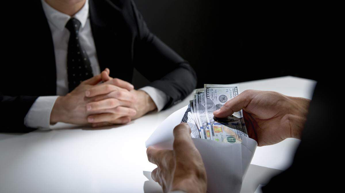 Businessman checking money, US dollars curency, in the envelope. Dark money.