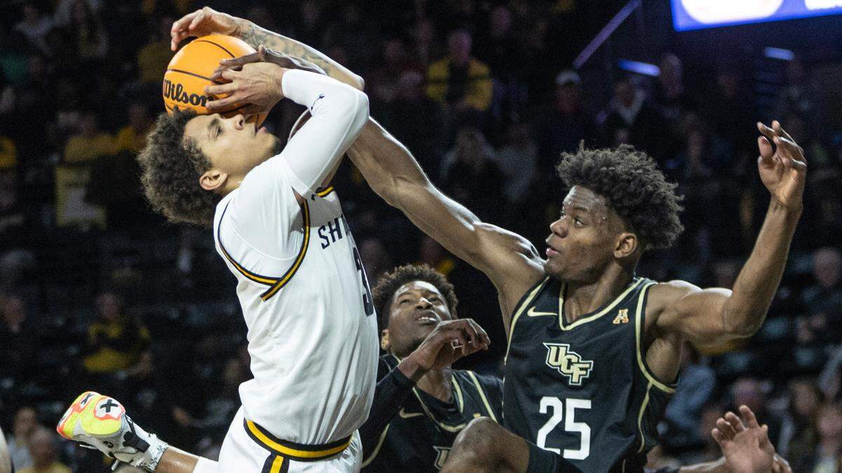 Wichita State’s Craig Porter Jr., is fouled on his way to the basket by Central Florida’s Taylor Hendricks during the second half on Wednesday. WIchita State squandered an 11-point second half lead to lose 72-67.