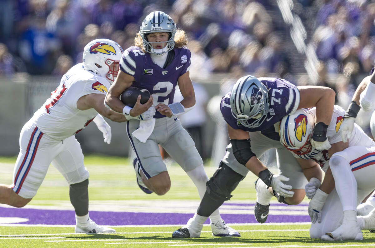 Kansas State quarterback Avery Johnson picks up a first down during the second half of their game against Kansas in Manhattan on Saturday.