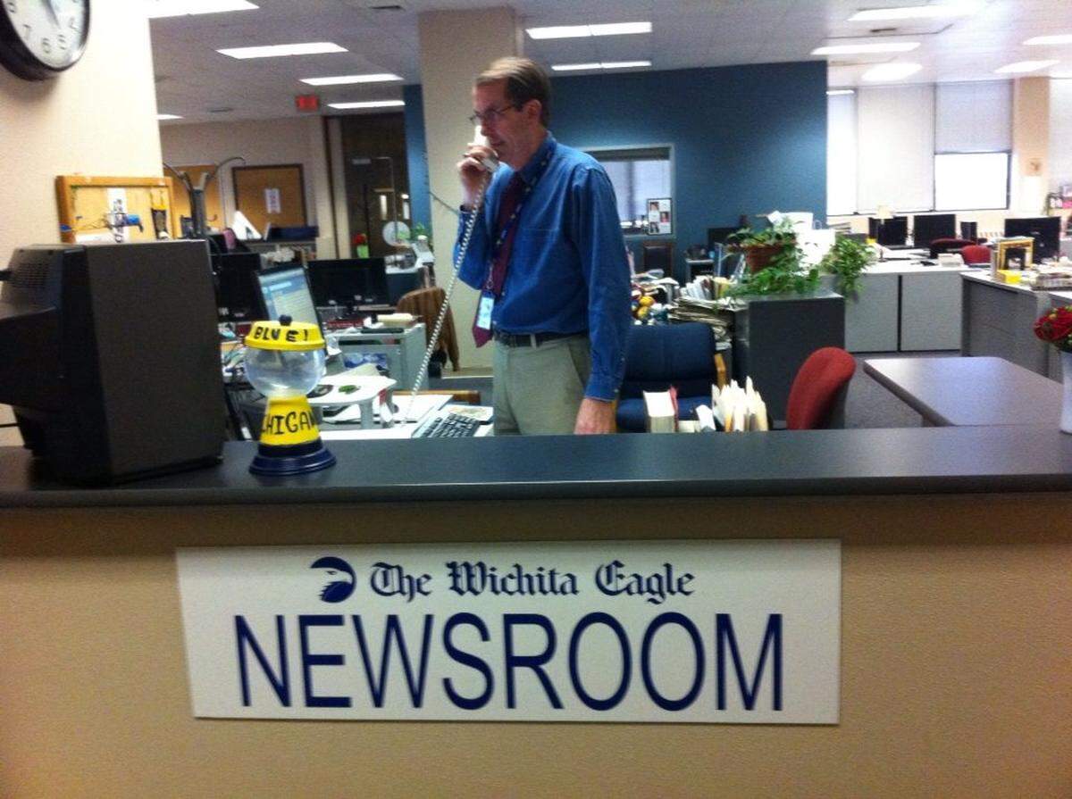 We liked to joke that Tom Shine was The Eagle’s receptionist because his desk was just off the elevator to our newsroom when we were at 825 E. Douglas across from Larkspur in Old Town. Note the empty University of Michigan candy holder on the left. Shine always kept Tootsie Rolls around since others liked them and he didn’t, so he wouldn’t be tempted to eat them.